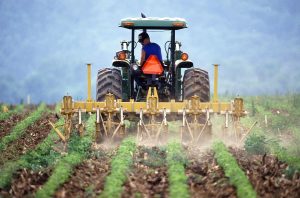 Tractor in a field spraying a chemical